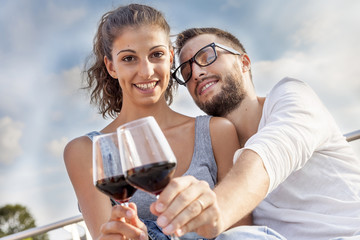 young couple farmers toasts in their vineyard