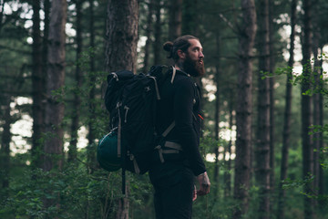 Obraz premium Beard man with backpack in forest