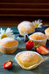 Delicious cake with strawberries on a vintage wooden background