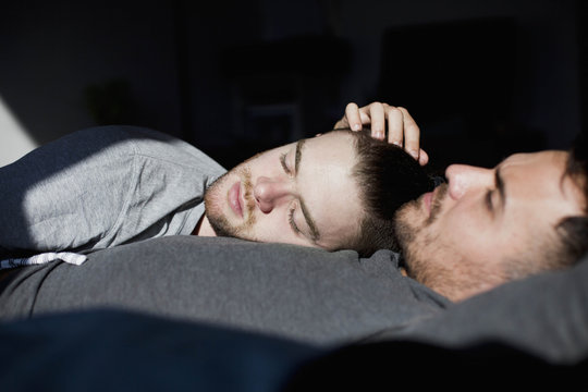 Couple lying on bed at home