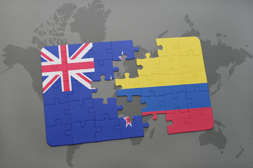 puzzle with the national flag of new zealand and colombia on a world map background