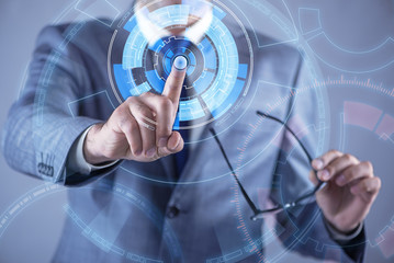 Businessman pressing virtual buttons in futuristic concept