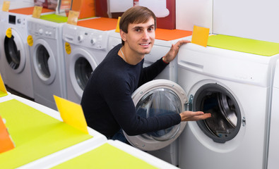 Man choosing new laundry machine.