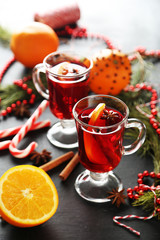 Mulled wine in glass on black wooden table