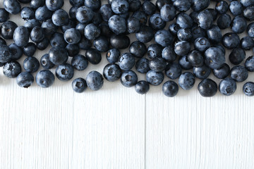 Blueberries on a white wooden background