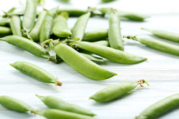Green peas on a blue wooden table