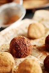 Sweet chocolate truffle on a black wooden table