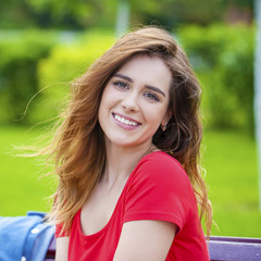 Beautiful young brunette girl in a red dress