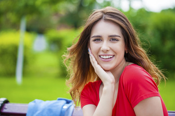Naklejka premium Beautiful young brunette girl in a red dress