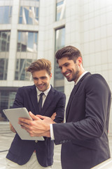 Handsome young businessmen with gadget