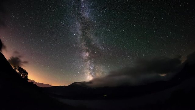 The outstanding beauty of the Milky Way and the starry sky captured at high altitude in summertime on the Italian French Alps, Torino Province and Savoie. Time Lapse 4k video.