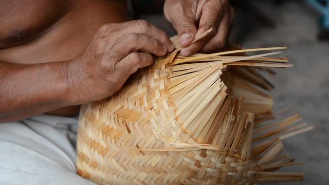 Close- up man weaving bamboo basket, People are demonstrating weaving baskets made from bamboo