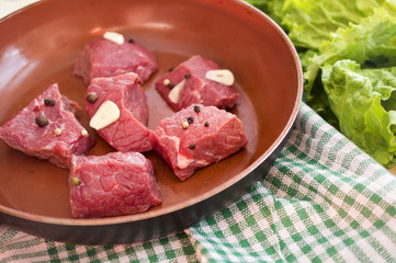 cuts of beef with spices in a pan