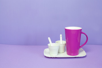 mug and coffee cup on a lilac background