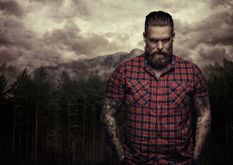 Bearded tattooed male in a red shirt.