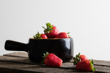 Juicy strawberry in clay vessel