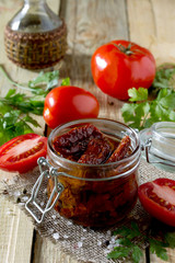 Sun dried tomatoes on a wooden table in rustic style