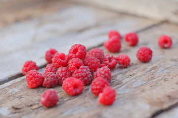 raspberry lying on wooden boards