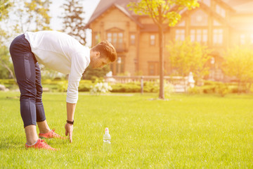 Naklejka premium Healthy male athlete doing exercise in nature