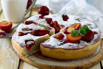 Plum cake sponge cake with poppy seeds on a wooden table, select