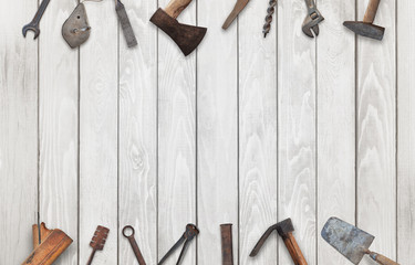 Old tools on wooden table with free space for text. Traditional handmade tools for craftsmen.