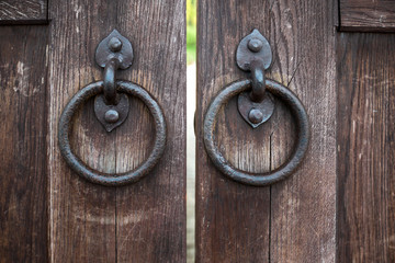 Part of oak doors with wrought iron handles in the form of rings