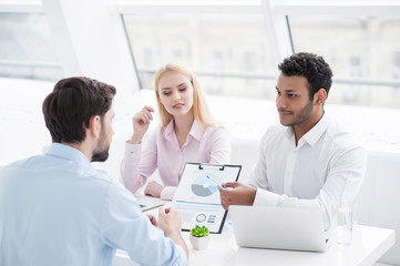 Fototapeta premium Young coworkers having brainstorming session in modern office