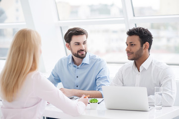 Fototapeta premium Young coworkers having brainstorming session in modern office