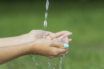 Closeup female hands under running water transparent. 