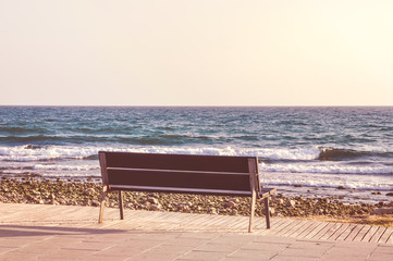 Empty bench overlooking Mediterranean sea. Vintage effect.