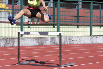 young female athlete running the obstacle course