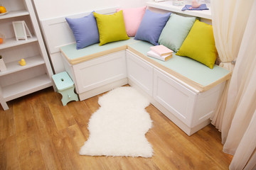Fototapeta na wymiar Colorful pillows on nook furniture