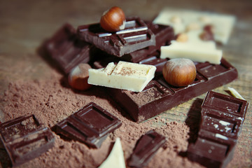 Mix of chocolate with nuts on wooden table
