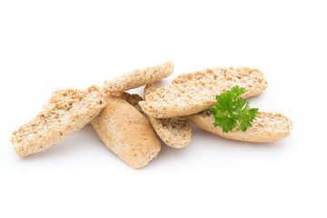 Dry flat bread crisps with herbs on a white background.