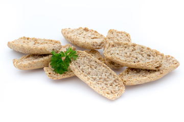 Dry flat bread crisps with herbs on a white background.
