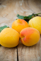 Fresh apricots on the wooden table.