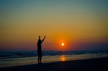 Silhouette man show his hands up