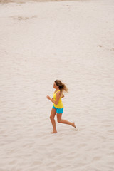 Young woman running on the beach