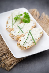 Crispbread with soft cheese with herbs and bacon.