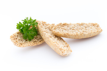 Dry flat bread crisps with herbs on a white background.