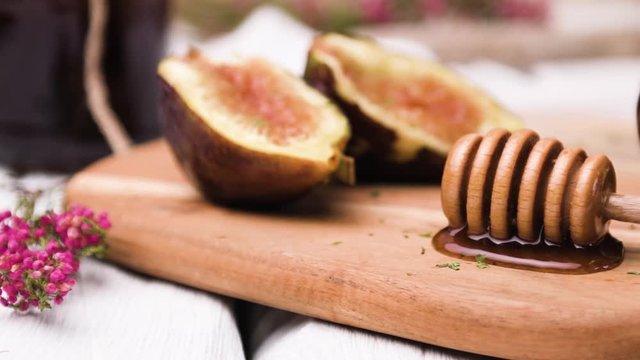 Figs and honey on a wooden table selective focus.