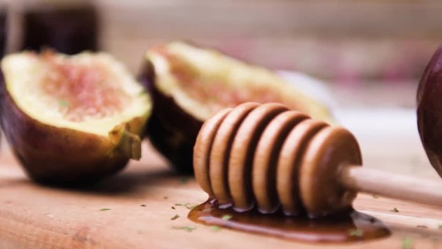 Figs and honey on a wooden table selective focus.