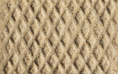 closeup of sand pattern of a beach in the summer
