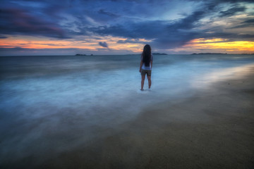 Woman stan, Turquoise sea wave at rayong Thailand. 