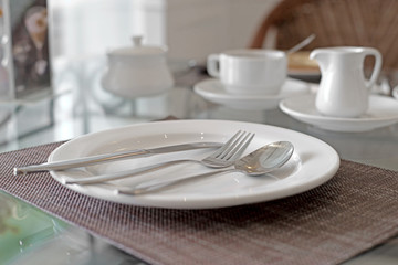 spoon fork and knife on white plate