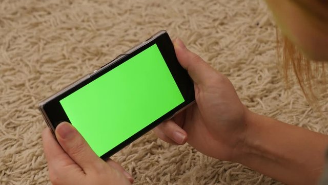 Green screen cell phone holding in hands 4K 2160p UHD footage - Woman holding smart phone green screen in hands 4K 3840X2160 UHD video 