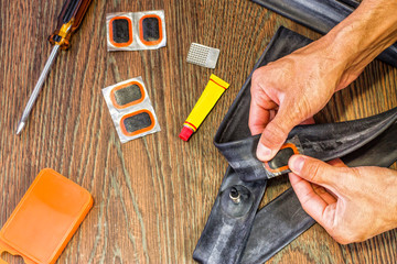 bicycle repair kit, wheels camera on a wooden background