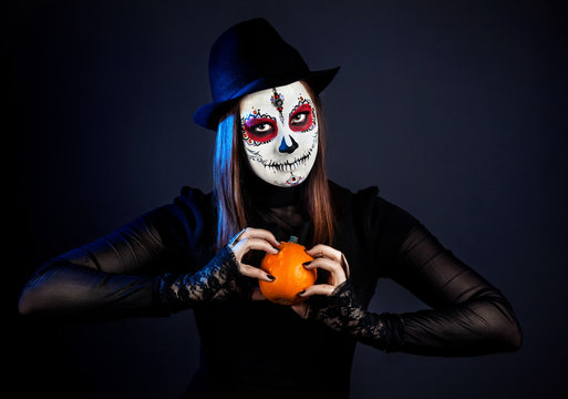 Sugar skull girl with pumpkin