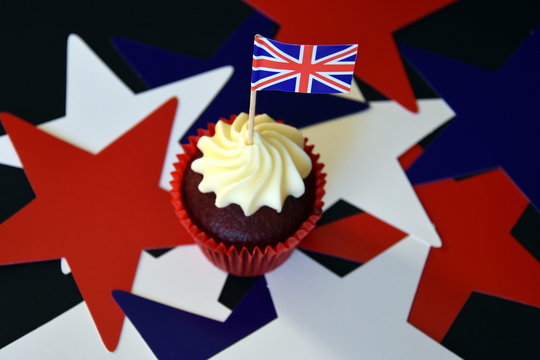 UK Celebration Cake, Party Food With Red, White And Blue Cupcake And British Flag.  Celebration, Patriotism And Holidays Concept - Close Up Of Glazed Muffin Decorated With British Flag