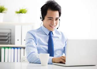 young businessman with headset working in office